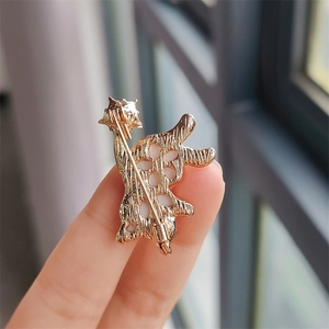 Close-up of the golden metal bunny brooch back with a secure pin fastening mechanism