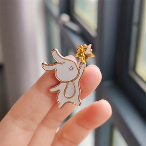 Close-up of a cute rabbit brooch with yellow star crystal and gold metal details