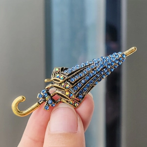 Exquisite retro umbrella brooch with blue rhinestones and bronze metal finish detail