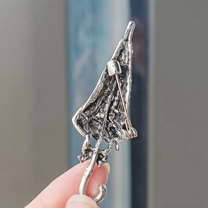 Close-up of the vintage silver umbrella brooch back with a secure pin fastening detail