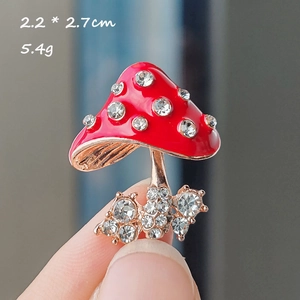 Detail showing 2.2x2.7cm red mushroom brooch with alloy inlay and white rhinestones