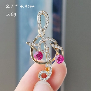 Sparkling treble clef musical note brooch with pink crystals and white rhinestones