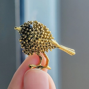 Vintage gold-tone sparrow bird brooch with textured alloy finish and black rhinestone eye