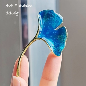 Ginkgo leaf brooch detail showing 4.4x6.6cm dimensions with blue enamel gradient finish