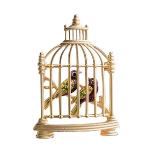 Vintage gold birdcage brooch with colorful enamel birds and intricate metal frame