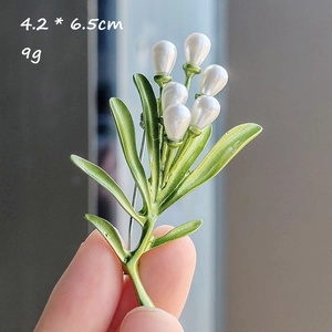 Detailed view of lily of the valley brooch with green leaves and white pearls 4.2x6.5cm