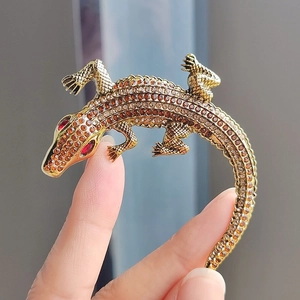 Golden crocodile brooch with amber gradient crystals and red rhinestone eyes