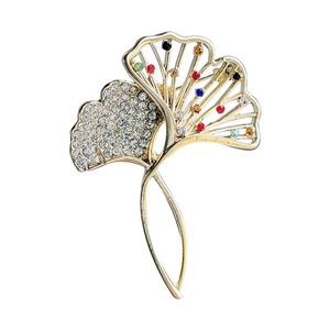 Golden ginkgo leaf brooch with sparkling colorful crystals and hollowed-out design