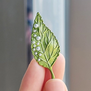 Elegant green leaf brooch with white pearls, featuring detailed vein textures for women