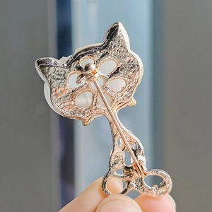 Exquisite gold fox brooch with opal stone showing the back metal pin structure
