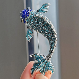 Exquisite koi fish brooch featuring shimmering blue rhinestones on silver metal base