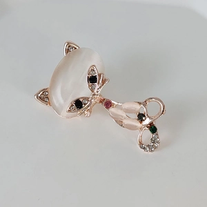 Detailed view of fox brooch with cat eye stone and colorful rhinestones in rose gold