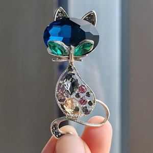 Charming silver cat brooch with vibrant multicolored crystals and cat-eye stones