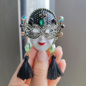 Venetian mask brooch with silver rhinestones, green gemstones and black tassels