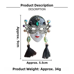 Detail view of Venetian mask brooch with green gemstones, rhinestones and black silk tassels