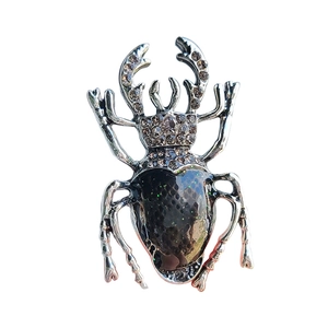 Vintage beetle brooch in silver finish with grey rhinestones and green glitter enamel