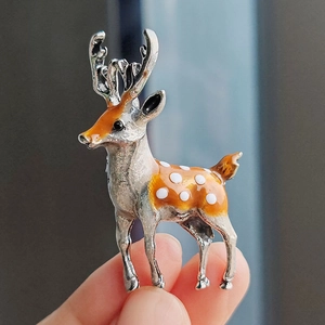 Elegant sika deer brooch in silver metal with orange enamel and white spots