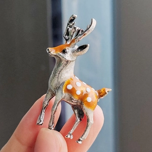 Elegant silver-tone sika deer brooch featuring orange enamel and white dots for women