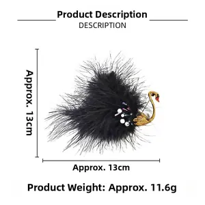 Detail view of a black feather swan brooch with gold metal neck and size measurement