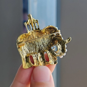 Vintage gold elephant and pagoda brooch with white pearls and brushed metal finish
