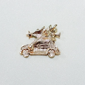 Detail view of the Christmas tree car brooch back showing metal base and safety pin closure