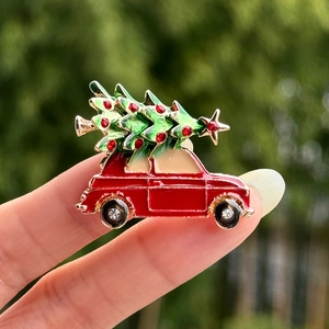 Macro view of Christmas tree car brooch with red oil drop and sparkling crystal wheels
