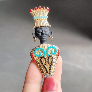 Tribal chief brooch featuring a golden crown and colorful gemstone inlays