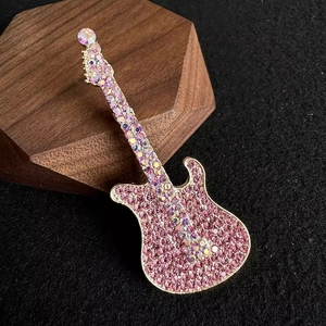 Minimalist guitar brooch featuring sparkling pink and iridescent crystal rhinestones