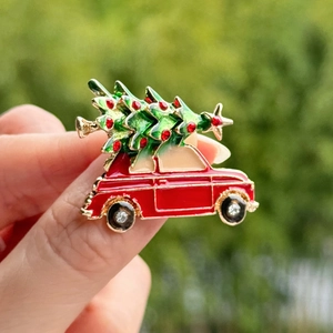 Detail of creative Christmas tree on red car brooch pin with enamel and rhinestones
