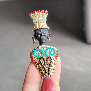 Close-up of exotic tribal chief brooch with colorful crystals and matte black finish
