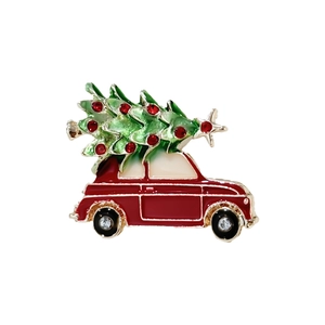 Christmas brooch featuring a vintage red car carrying a green tree with red rhinestones