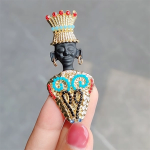 Detailed close-up of a vintage tribal chief brooch with colorful rhinestones and beads