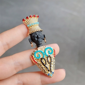 Detailed close-up of a tribal king brooch featuring colorful gemstones and gold texture