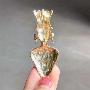 Reverse side of tribal chief brooch in brushed gold finish with safety pin clasp