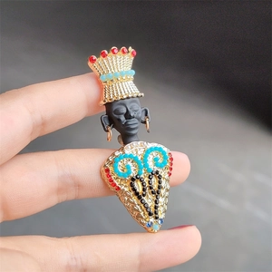 Detailed view of an exotic tribal chief brooch with colorful gemstones and golden metal