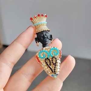 Vintage African tribal chief brooch with golden crown and colorful beaded pattern