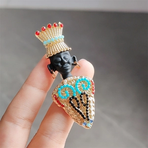 Detailed close-up of a vintage ethnic Moretto brooch with colorful gemstones and gold texture