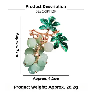 Detailed size view of grape brooch with green translucent beads and golden metal leaves