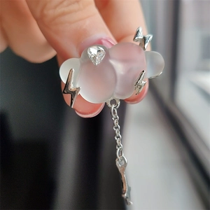 Detailed view of handmade pink cloud brooch with silver lightning and metallic chain