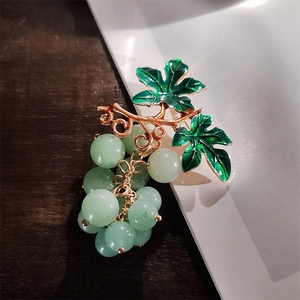Elegant gold metal grape brooch with green enamel leaves and light green translucent beads