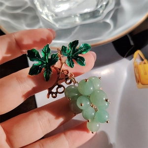 Elegant green grape cluster brooch with enamel leaf and translucent beads on bronze branch