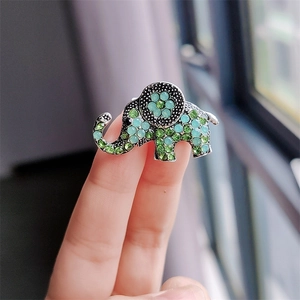 Detailed elephant brooch with sparkling green and blue rhinestones on a metal alloy base