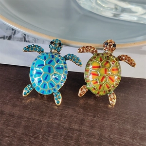 Creative turtle brooches with rhinestones and enamel oil finish on wooden surface