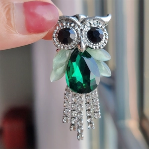 Silver owl brooch with large green pear-shaped crystal and sparkling tassel chains