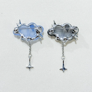Detail of the safety pin buckle and hanging star charm on cloud shaped brooches