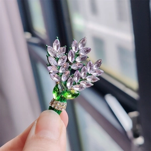 Detailed macro view of purple lavender bouquet brooch with inlaid crystals and rhinestones