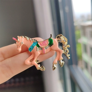 Simpatica spilla a forma di unicorno rosa con bordi dorati e dettagli in smalto