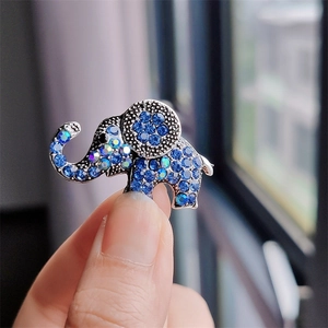 Detailed close-up of elephant brooch featuring sparkling blue rhinestones on silver alloy