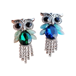 Exquisite owl earrings with emerald and sapphire rhinestones and sparkling tassel details