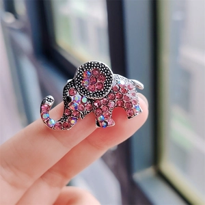 Macro view of a crystal elephant brooch showing pink rhinestones and size perspective